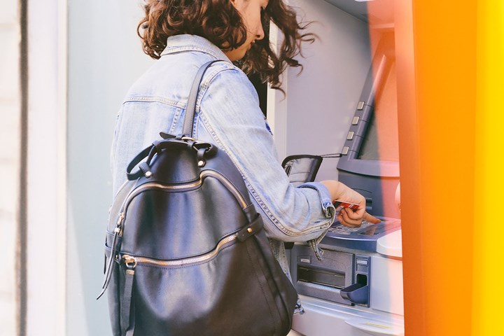 woman standing at ATM