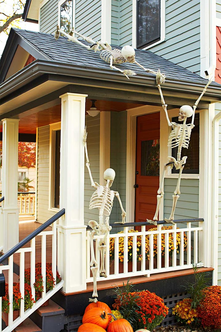 Funny Halloween skeletons posing on balcony