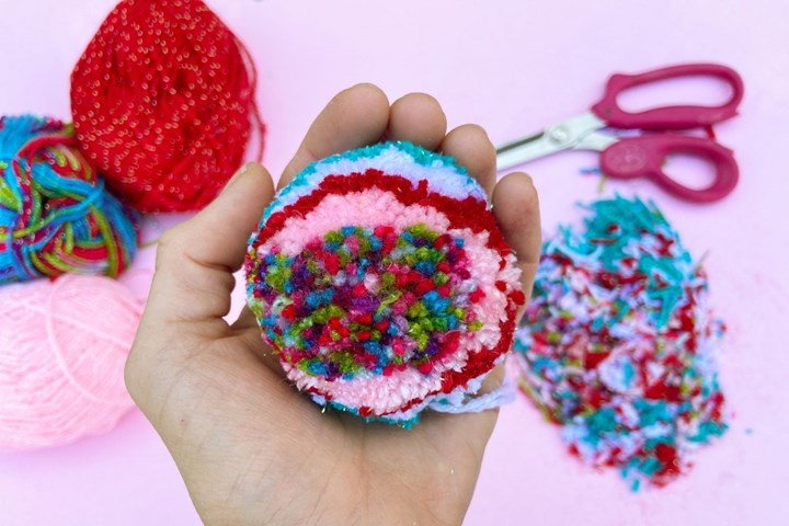 Once all loops have been cut, trim until you have a nice round shape. Repeat to make 6 pom-poms.