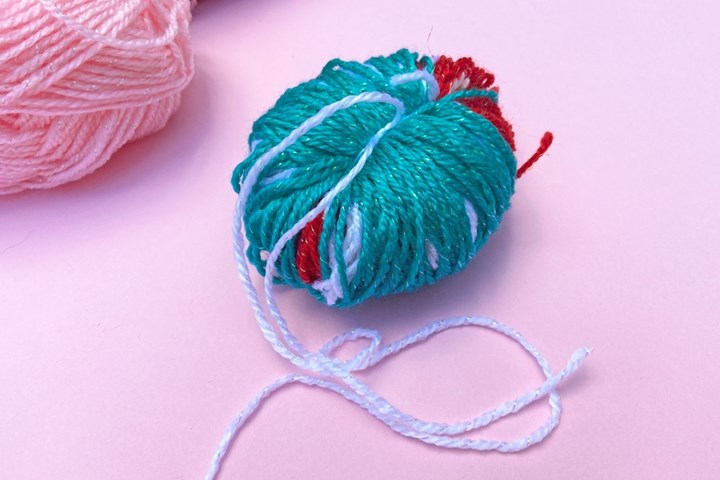 Slip the yarn off the spool then tighten your knot to secure.
