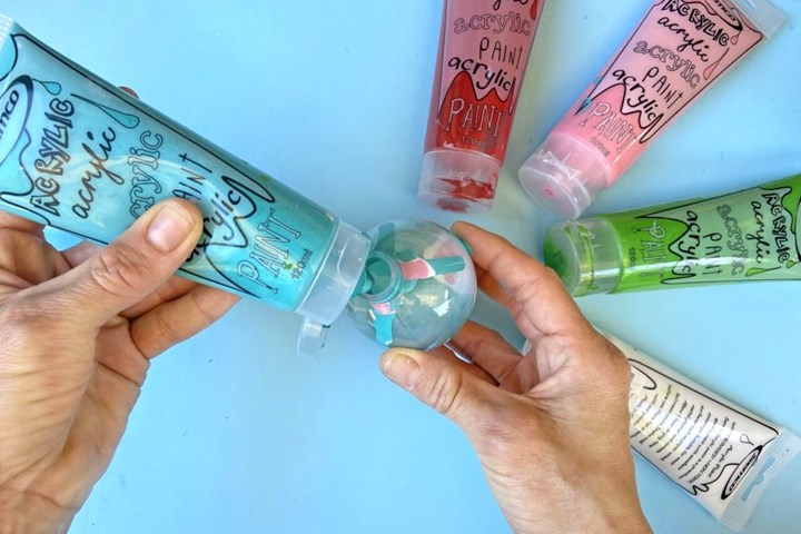 Remove the tops from your clear baubles and squirt a small amount of paint inside, in colours of your choosing.