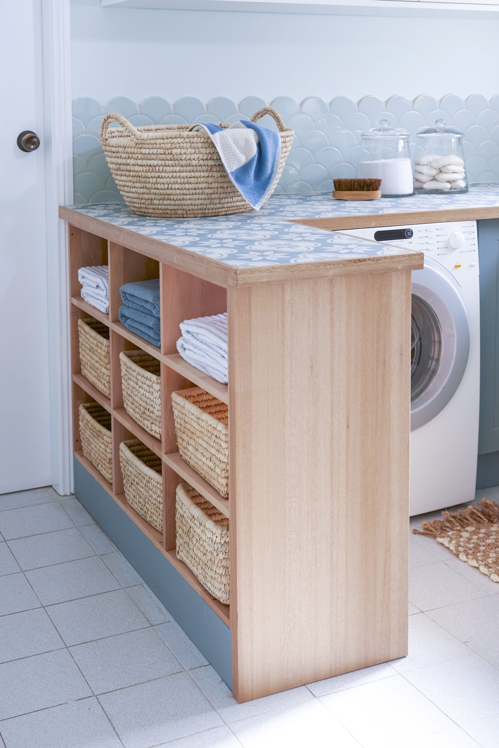 closeup of benchtop storage with towels and wicker baskets
