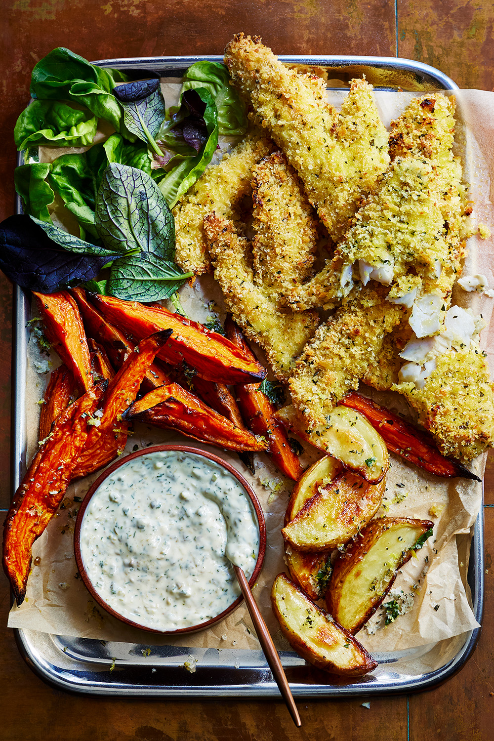 fish and chips tray bake with sweet potato chips and tartare sauce on the side